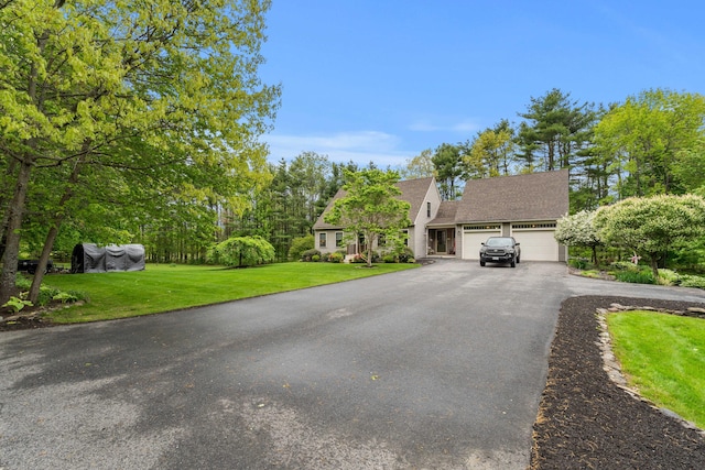 27 Wilmer Chase Rd, North Berwick, ME 03906 - view of front of home with an attached garage, asphalt driveway, a front yard, and roof with shingles