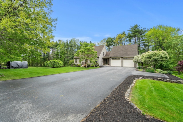 27 Wilmer Chase Rd, North Berwick, ME 03906 - view of front of property with driveway, an attached garage, a front lawn, and a shingled roof