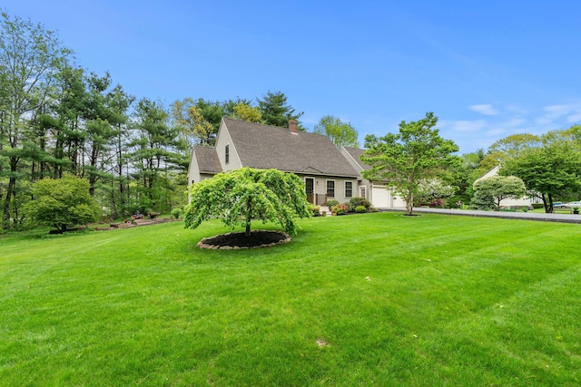 27 Wilmer Chase Rd, North Berwick, ME 03906 - view of front of property with a garage, a front yard, a shingled roof, and a chimney