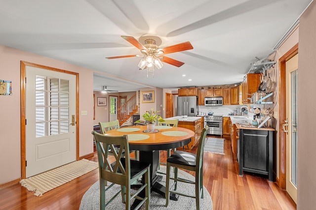 27 Wilmer Chase Rd, North Berwick, ME 03906 - dining space featuring stairway, light wood-type flooring, a ceiling fan, and plenty of natural light