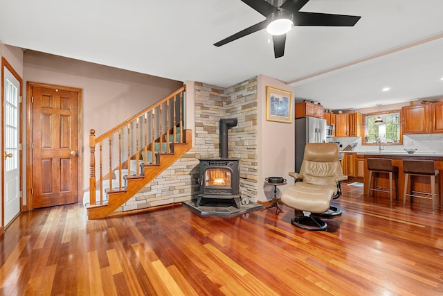 27 Wilmer Chase Rd, North Berwick, ME 03906 - living room with a wood stove, wood finished floors, ceiling fan, and stairway