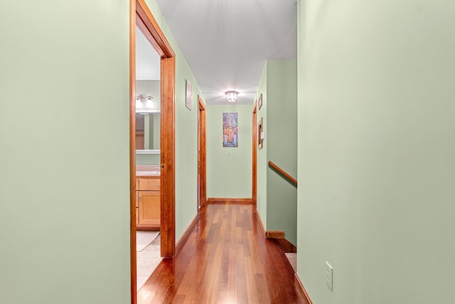 27 Wilmer Chase Rd, North Berwick, ME 03906 - hallway with wood finished floors, an upstairs landing, and baseboards