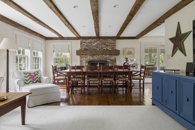 52 Lester B Orcutt Blvd, Biddeford, ME 04006 - dining room featuring a brick fireplace, healthy amount of natural light, beam ceiling, and wood finished floors