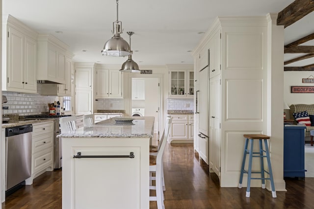 52 Lester B Orcutt Blvd, Biddeford, ME 04006 - kitchen with stainless steel appliances, a breakfast bar area, tasteful backsplash, a kitchen island, and light stone counters