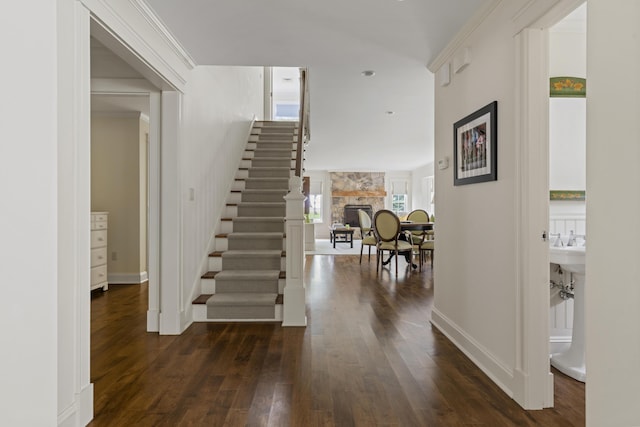 52 Lester B Orcutt Blvd, Biddeford, ME 04006 - entrance foyer with dark wood-style flooring, stairs, a fireplace, and baseboards