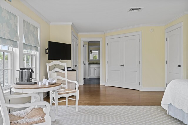 52 Lester B Orcutt Blvd, Biddeford, ME 04006 - bedroom featuring wood finished floors, multiple windows, ornamental molding, baseboards, and a closet