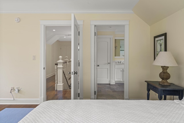 52 Lester B Orcutt Blvd, Biddeford, ME 04006 - bedroom with baseboards, dark wood-type flooring, ornamental molding, ensuite bath, and recessed lighting