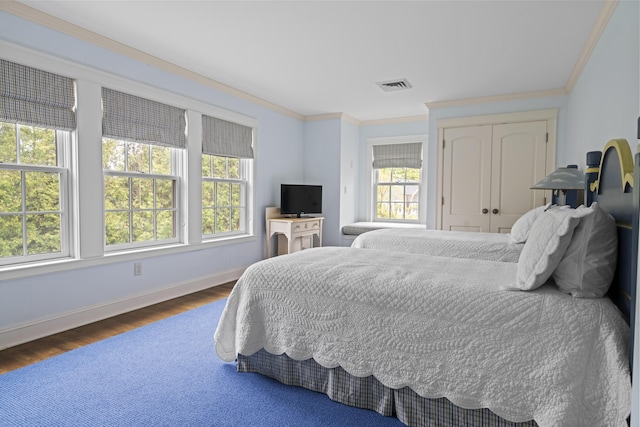 52 Lester B Orcutt Blvd, Biddeford, ME 04006 - bedroom featuring wood finished floors, baseboards, ornamental molding, and a closet