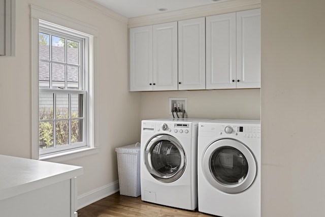 52 Lester B Orcutt Blvd, Biddeford, ME 04006 - washroom with cabinet space, baseboards, wood finished floors, and separate washer and dryer