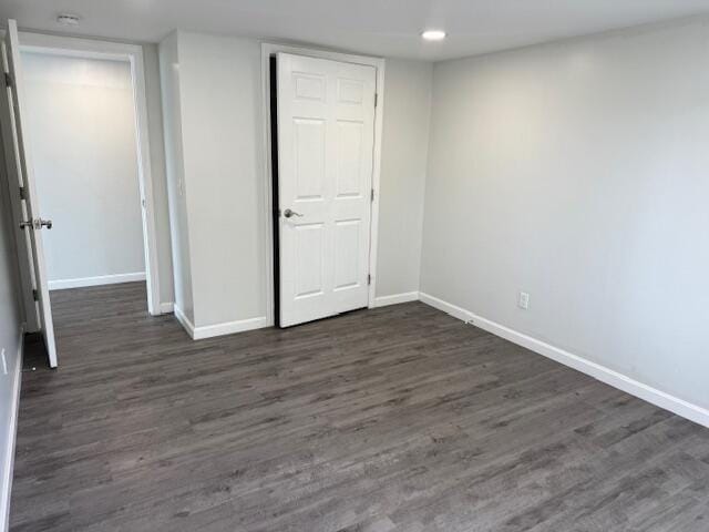 5 N Vigue Shore Rd, Albion, ME 04910 - unfurnished bedroom with baseboards, dark wood finished floors, a closet, and recessed lighting