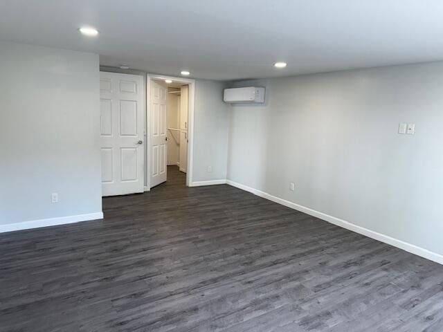 5 N Vigue Shore Rd, Albion, ME 04910 - finished below grade area with baseboards, a wall unit AC, dark wood finished floors, and recessed lighting