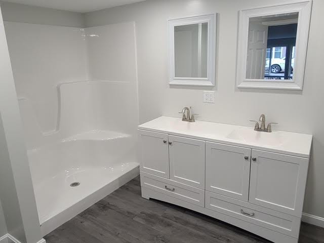 5 N Vigue Shore Rd, Albion, ME 04910 - bathroom with wood finished floors, double vanity, and a shower