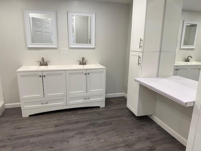5 N Vigue Shore Rd, Albion, ME 04910 - full bath with wood finished floors, double vanity, and baseboards
