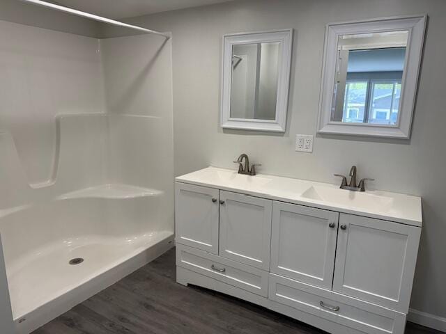 5 N Vigue Shore Rd, Albion, ME 04910 - full bathroom featuring wood finished floors, double vanity, and a shower