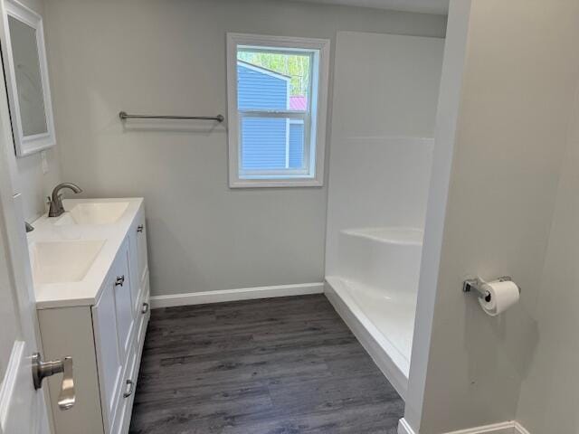 5 N Vigue Shore Rd, Albion, ME 04910 - full bathroom with baseboards, double vanity, and wood finished floors