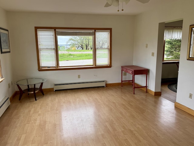 2 Cemetery Rd, Eastport, ME 04631 - empty room with a baseboard heating unit, a ceiling fan, light wood finished floors, and baseboards