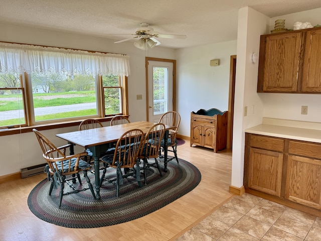 2 Cemetery Rd, Eastport, ME 04631 - dining space featuring a ceiling fan, light wood finished floors, and baseboards