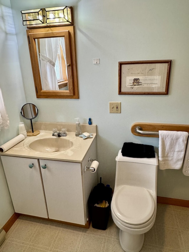 2 Cemetery Rd, Eastport, ME 04631 - half bathroom featuring vanity, toilet, and baseboards