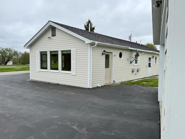 2 Cemetery Rd, Eastport, ME 04631 - view of property exterior featuring roof with shingles and a patio