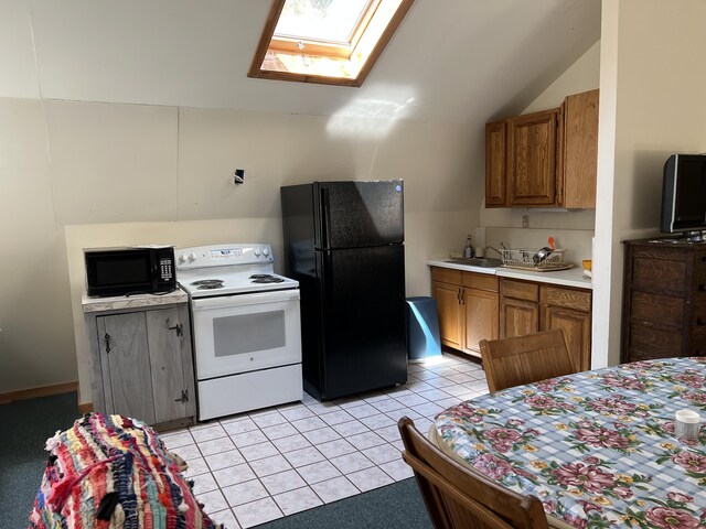 640 Bald Mountain Rd, Rangeley, ME 04970 - kitchen featuring black appliances, a skylight, lofted ceiling, brown cabinetry, and light countertops