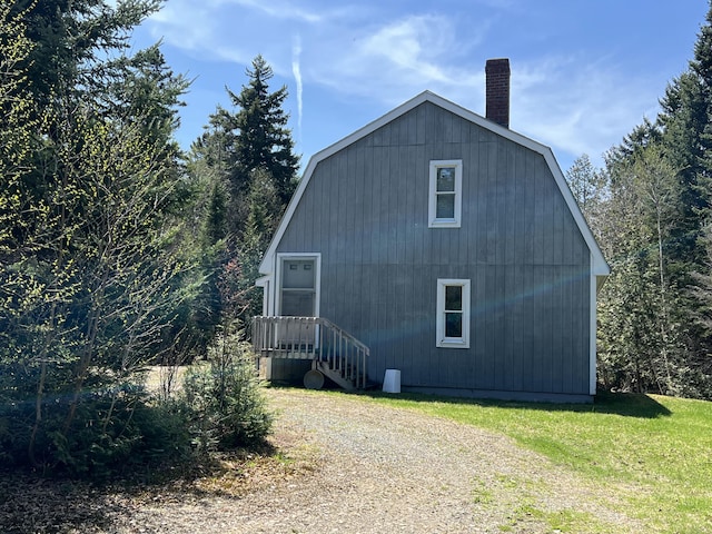 640 Bald Mountain Rd, Rangeley, ME 04970 - view of property exterior featuring a gambrel roof, a chimney, and a lawn
