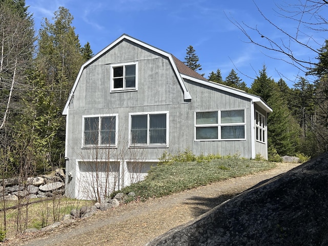 640 Bald Mountain Rd, Rangeley, ME 04970 - view of home's exterior featuring a gambrel roof and an attached garage