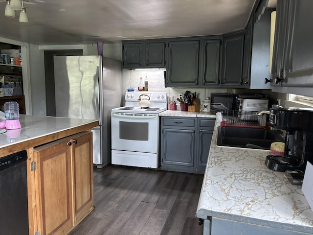 1407 Stage Rd, Etna, ME 04434 - kitchen with white range with electric cooktop, dishwasher, dark wood-type flooring, light countertops, and freestanding refrigerator