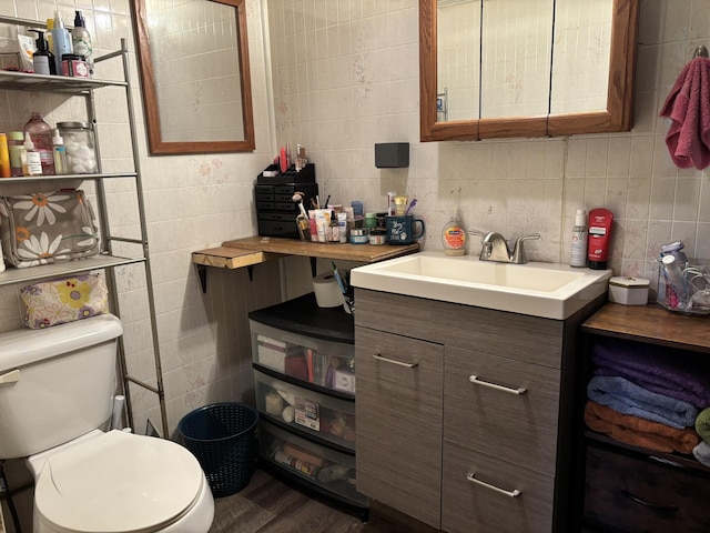 1407 Stage Rd, Etna, ME 04434 - half bath with tile walls, vanity, and wood finished floors