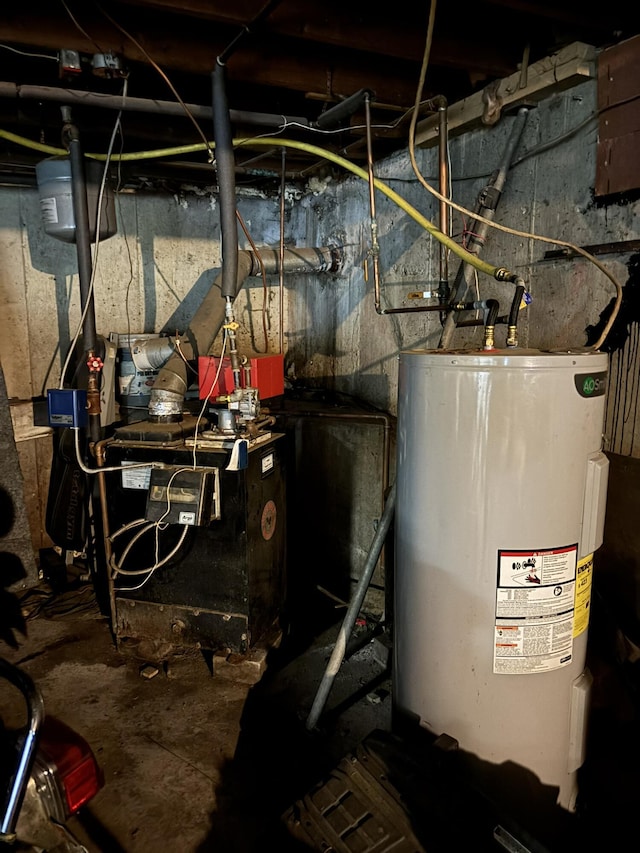 1407 Stage Rd, Etna, ME 04434 - utility room featuring electric water heater and a heating unit