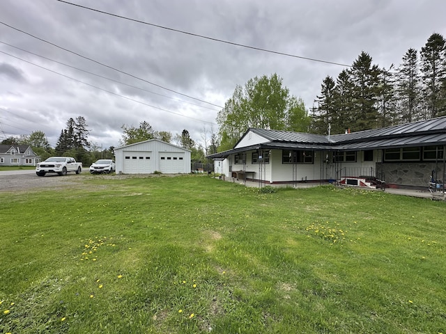 694 Calais Rd, Hodgdon, ME 04730 - view of grassy yard with a detached garage and an outdoor structure