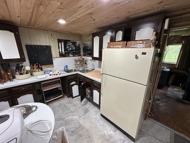 694 Calais Rd, Hodgdon, ME 04730 - kitchen featuring freestanding refrigerator, wood ceiling, a sink, light countertops, and dark brown cabinets