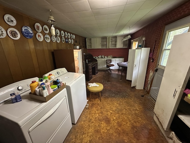 694 Calais Rd, Hodgdon, ME 04730 - washroom featuring washing machine and dryer, wood walls, and dark floors
