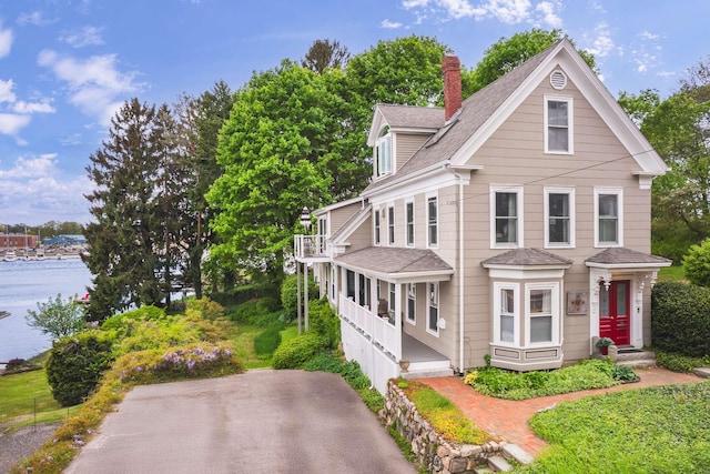 116 Whipple Rd, Kittery, ME 03904 - view of front of home featuring roof with shingles, a chimney, entry steps, and a water view