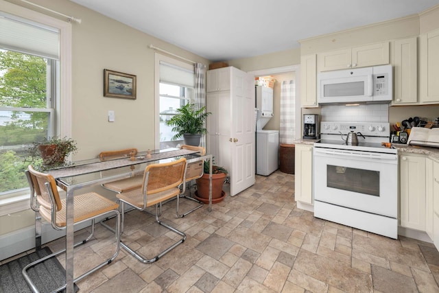 116 Whipple Rd, Kittery, ME 03904 - kitchen featuring white appliances, stacked washer / dryer, healthy amount of natural light, and decorative backsplash