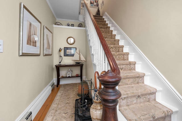 116 Whipple Rd, Kittery, ME 03904 - stairway featuring crown molding, wood finished floors, baseboard heating, and a baseboard heating unit