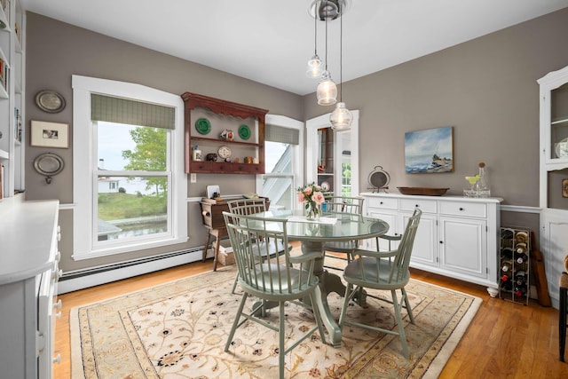 116 Whipple Rd, Kittery, ME 03904 - dining room with a baseboard heating unit and light wood-style flooring