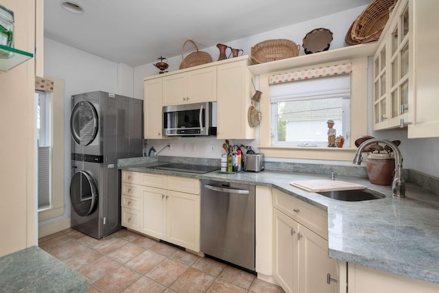 116 Whipple Rd, Kittery, ME 03904 - kitchen with stainless steel appliances, stacked washer / dryer, a sink, glass insert cabinets, and light tile patterned floors