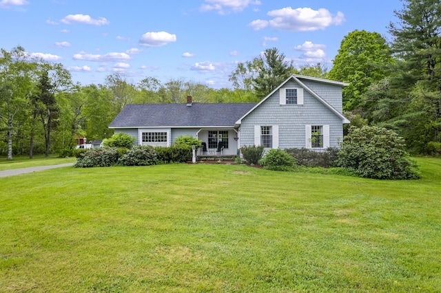 14 Lakeshore Dr, Belgrade, ME 04918 - view of front facade with a front lawn, a chimney, and roof with shingles