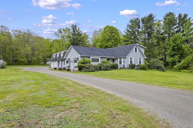 14 Lakeshore Dr, Belgrade, ME 04918 - view of front of house with a front yard, driveway, a chimney, and a shingled roof
