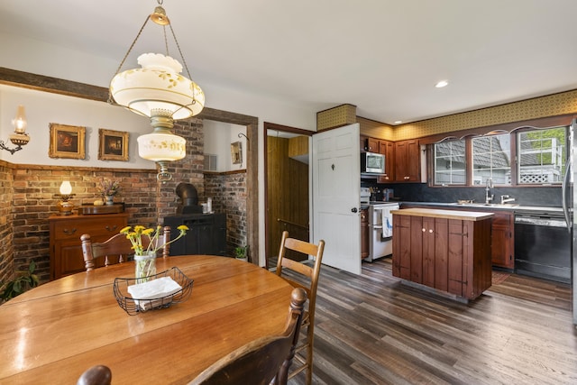 14 Lakeshore Dr, Belgrade, ME 04918 - dining area with a wood stove, dark wood-type flooring, and brick wall