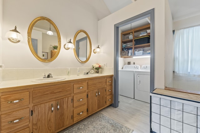 14 Lakeshore Dr, Belgrade, ME 04918 - full bathroom featuring washer and dryer, double vanity, lofted ceiling, and wood finished floors