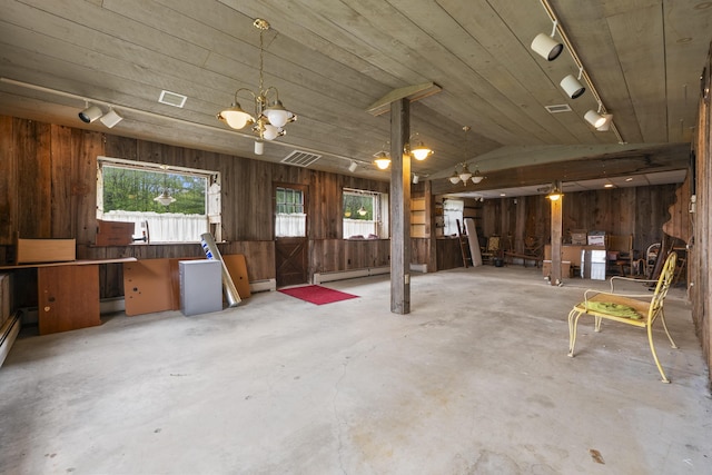 14 Lakeshore Dr, Belgrade, ME 04918 - misc room featuring track lighting, plenty of natural light, a baseboard radiator, wood walls, and concrete floors