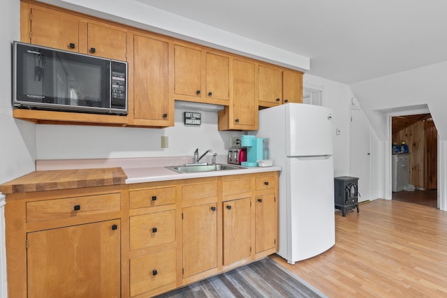 14 Lakeshore Dr, Belgrade, ME 04918 - kitchen with a sink, freestanding refrigerator, black microwave, light wood-style floors, and light countertops