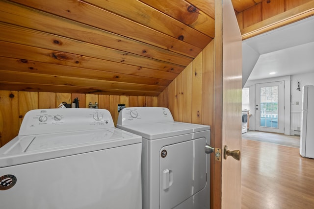 14 Lakeshore Dr, Belgrade, ME 04918 - laundry area featuring washing machine and dryer, light wood-style flooring, and wooden walls
