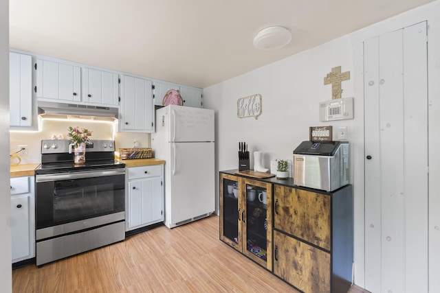 14 Lakeshore Dr, Belgrade, ME 04918 - kitchen featuring stainless steel electric range oven, freestanding refrigerator, under cabinet range hood, light wood-style flooring, and light countertops