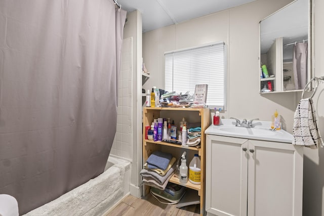 14 Lakeshore Dr, Belgrade, ME 04918 - full bath with wood finished floors, vanity, and shower / bath combination with curtain