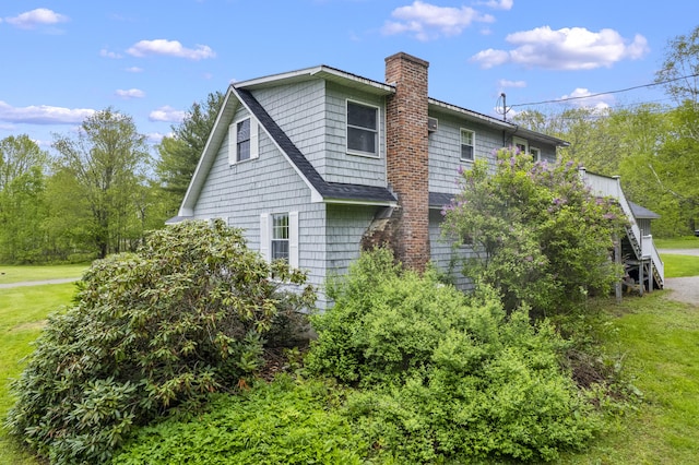 14 Lakeshore Dr, Belgrade, ME 04918 - view of home's exterior with a chimney and a lawn