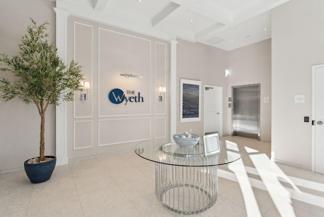 267 US Route 1 Unit 206, Falmouth, ME 04105 - foyer entrance featuring elevator, coffered ceiling, beamed ceiling, a high ceiling, and a decorative wall