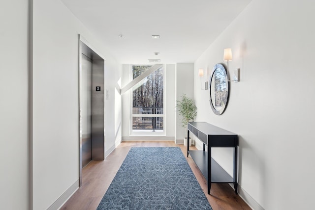 267 US Route 1 Unit 206, Falmouth, ME 04105 - hallway featuring elevator, wood finished floors, and baseboards