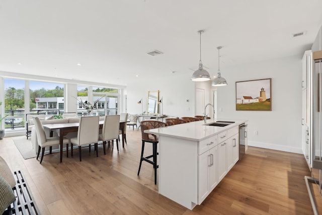 267 US Route 1 Unit 206, Falmouth, ME 04105 - kitchen featuring a sink, open floor plan, dishwasher, light wood finished floors, and recessed lighting